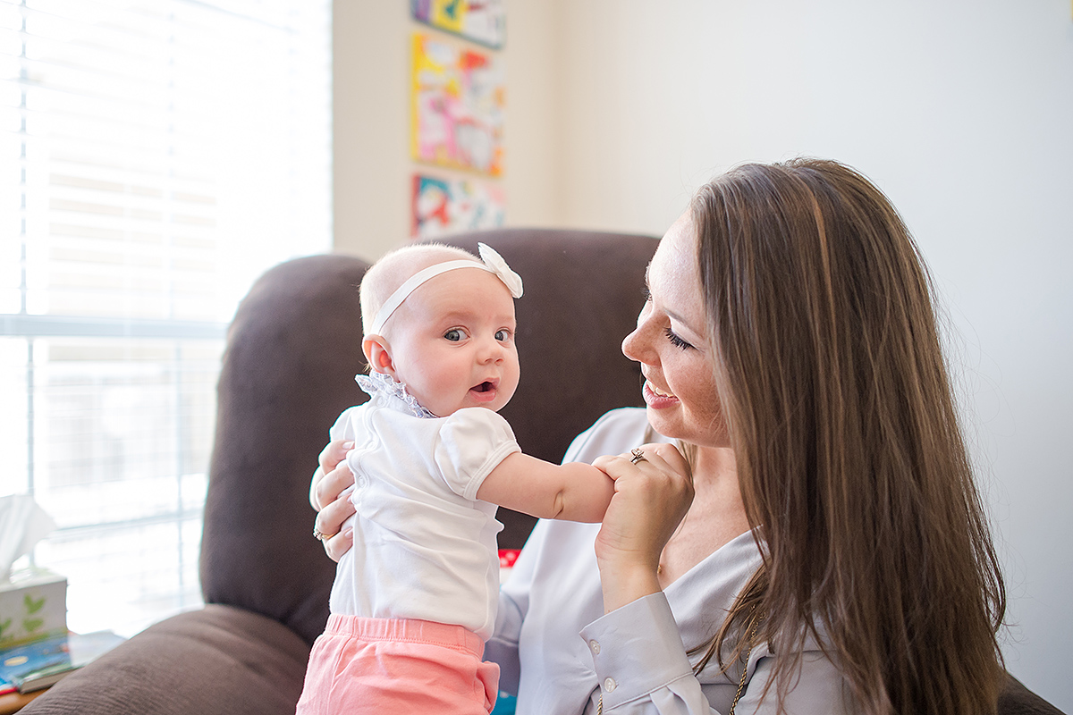 mommy looking at baby girl for photographs