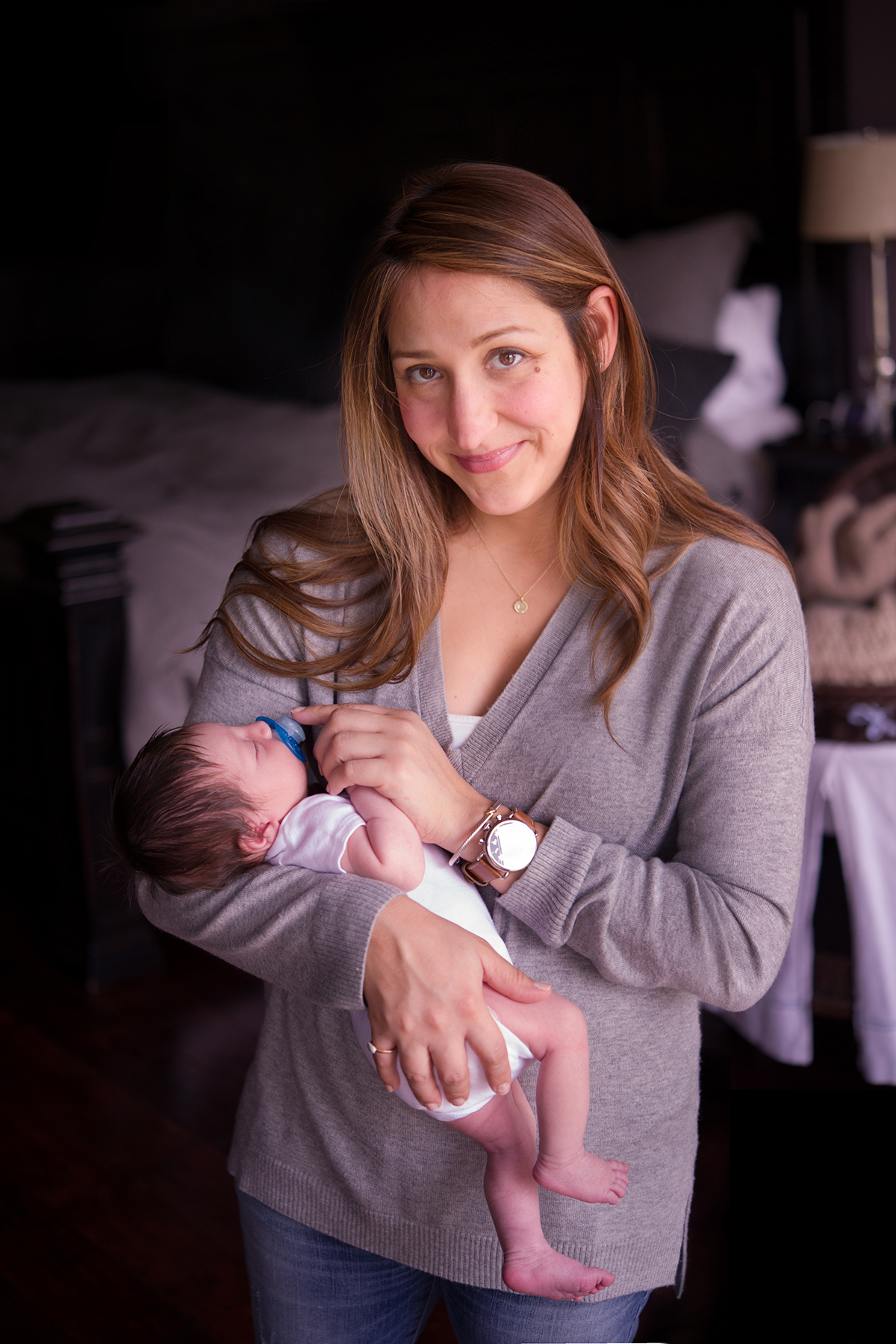 momma smiles at newborn family photography Houston